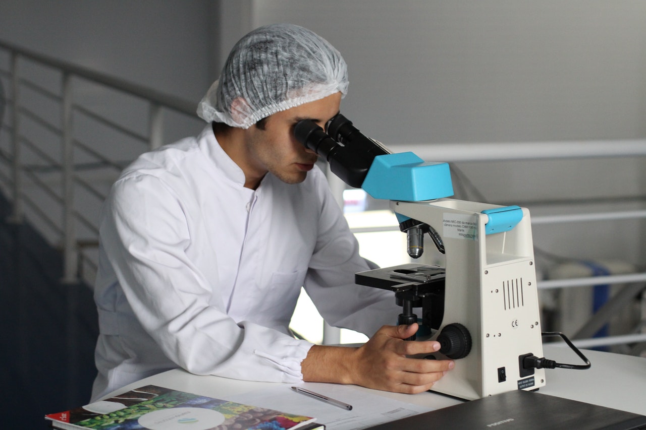researcher using microscope